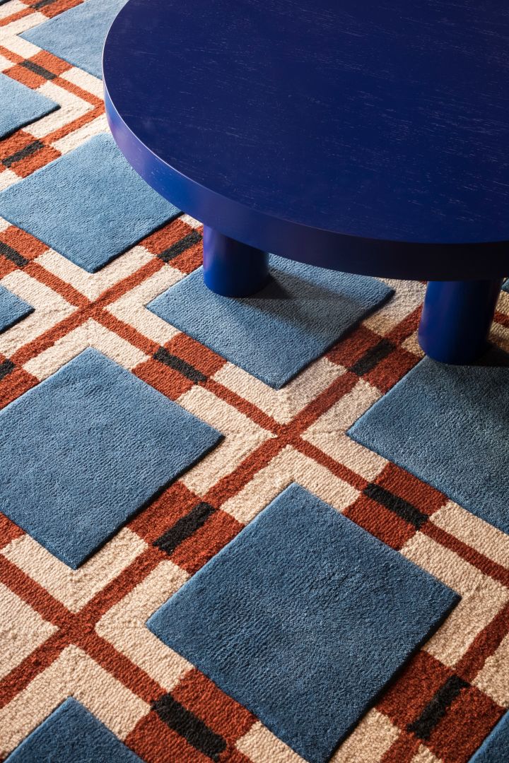 Patterned carpet in red and blue geometric pattern from Layered - the carpet to bet on for autumn 2023 interior design trends. 