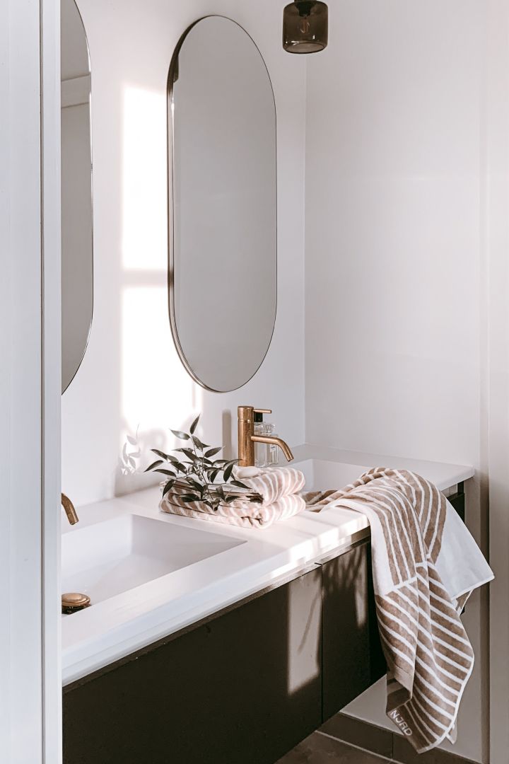 The beige striped towel from NJRD draped over the sink in the home of Swedish influencer @arkihem. 