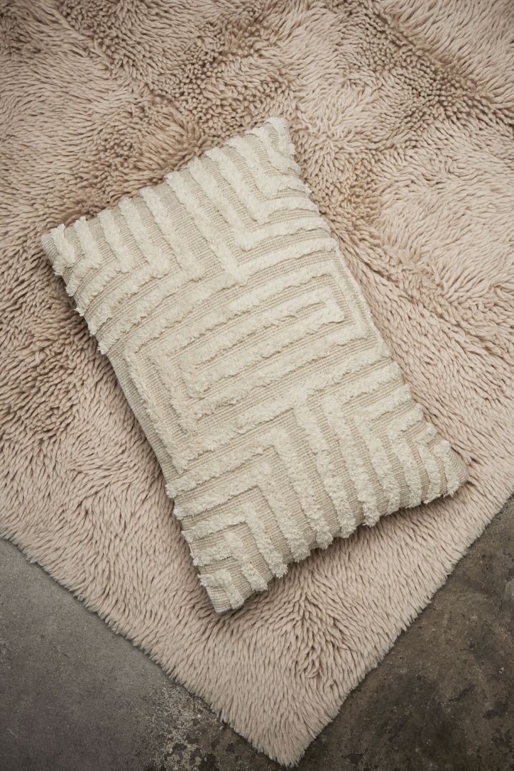 Here you see a beige cushion from Swedish brand Tinted Objects with a raised fluffy squared shaped pattern. 