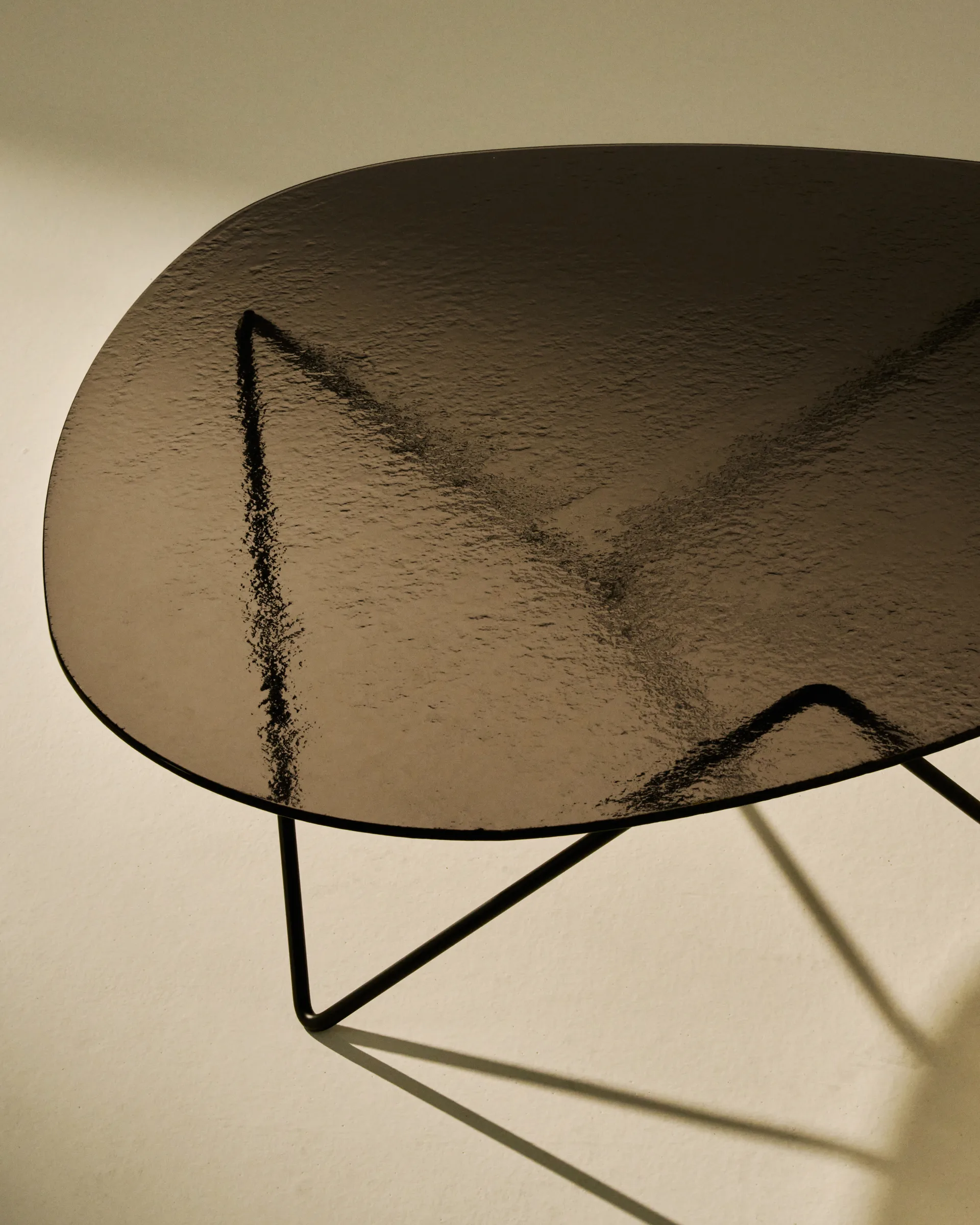 Pedrera sofa table, Black semi-matte—bronze textured glass GUBI