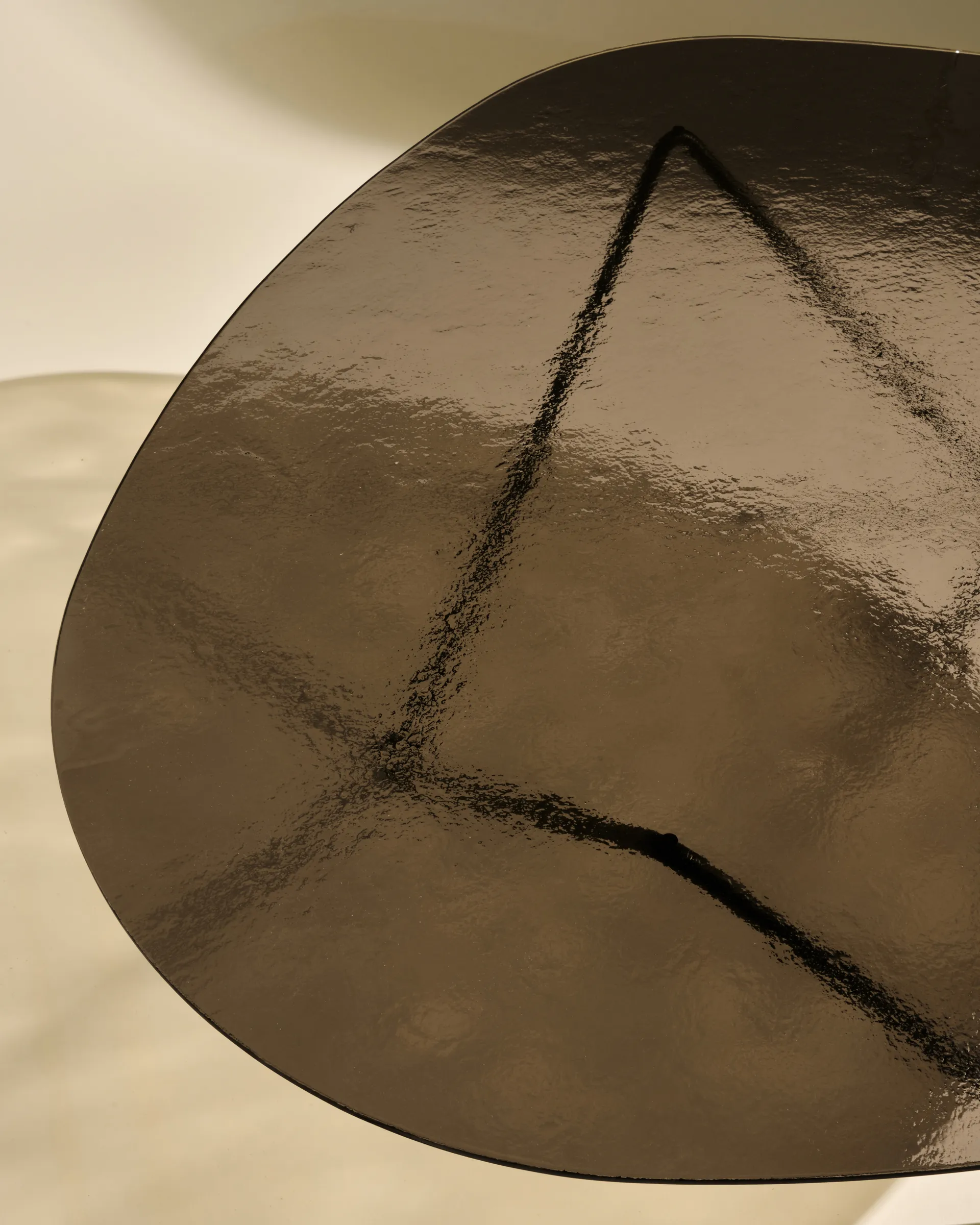 Pedrera sofa table, Black semi-matte—bronze textured glass GUBI