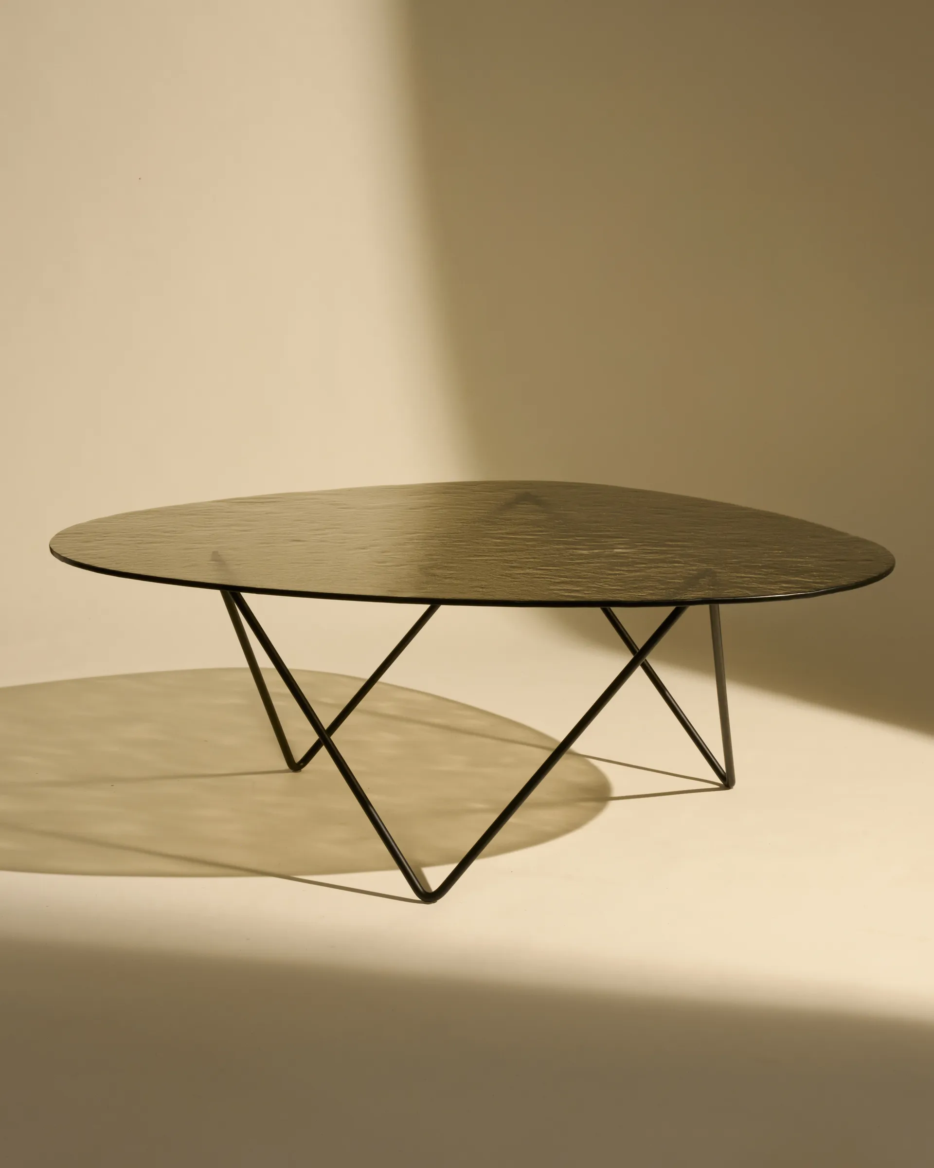 Pedrera sofa table, Black semi-matte—bronze textured glass GUBI