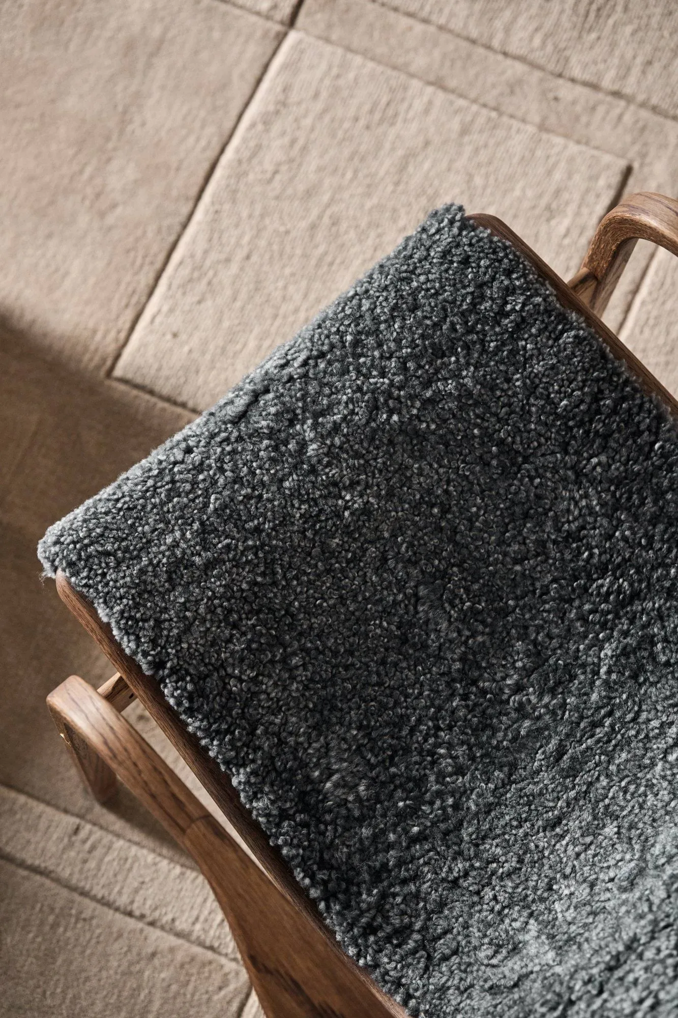 Lamino armchair and footstool, Sheepskin Charcoal-Rubio Monocoat Chocolate Swedese