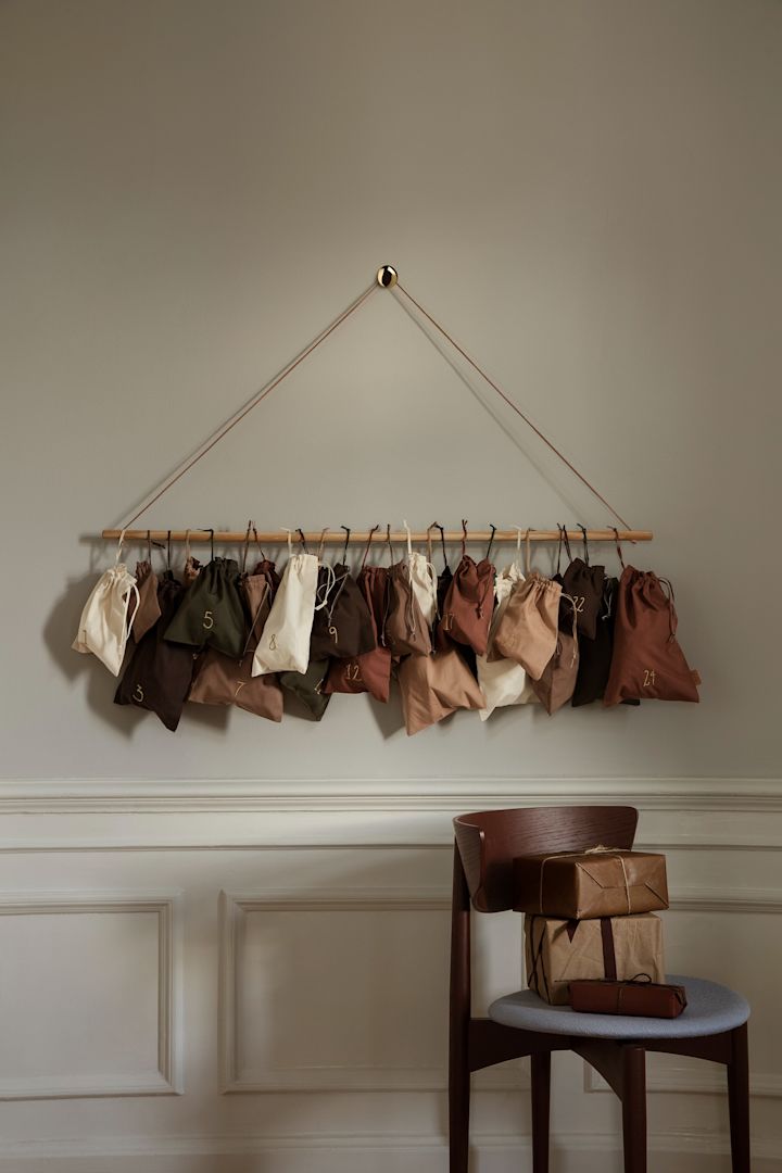 Scandi Christmas decorations from Ferm Living - a beautiful Christmas calendar consisting of fabric bags that are hung on the wall in earthy colors.
