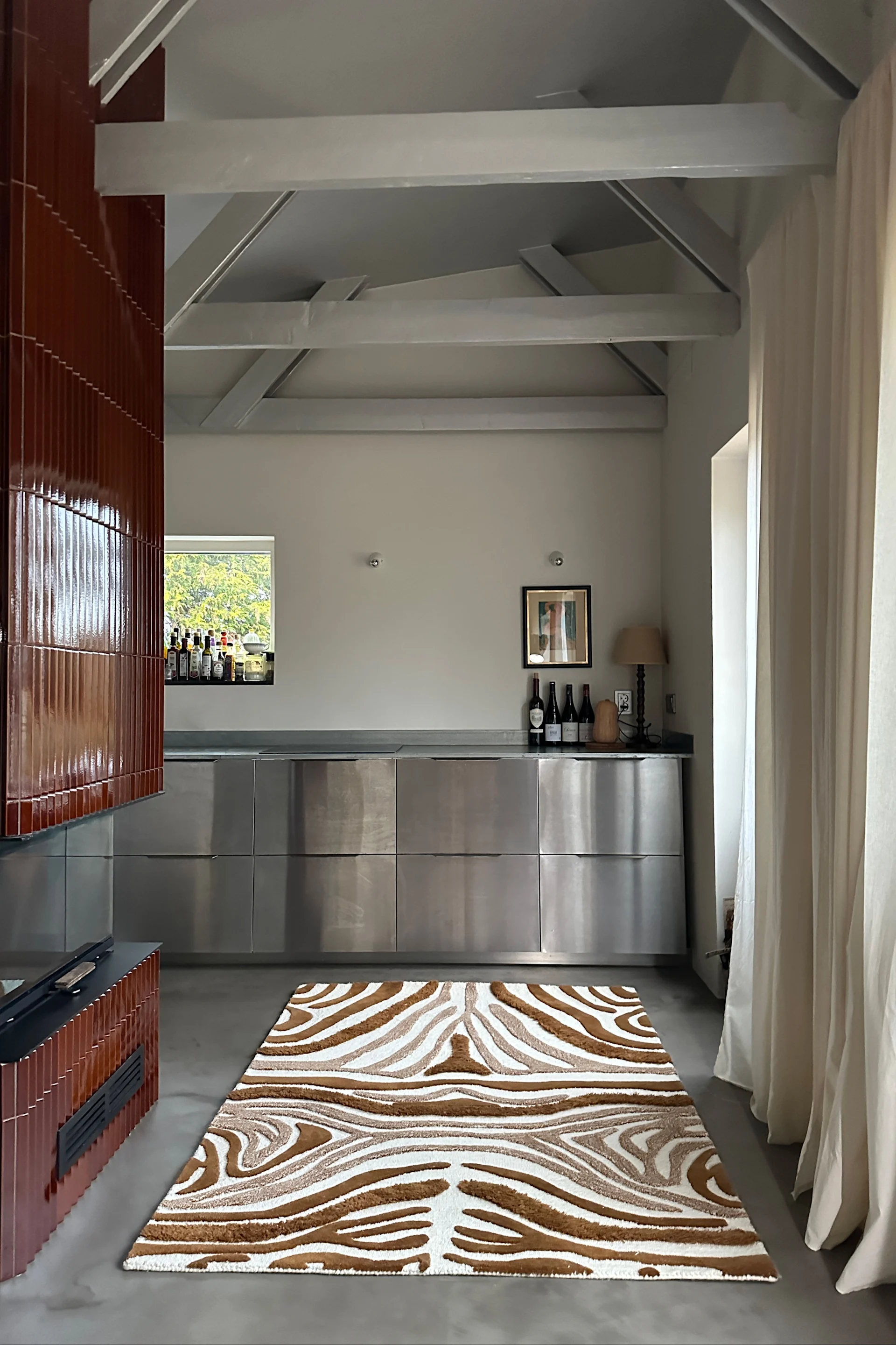 A zebra-patterned rug that reflects the interior design trends of 2026 and highlights statement rugs.