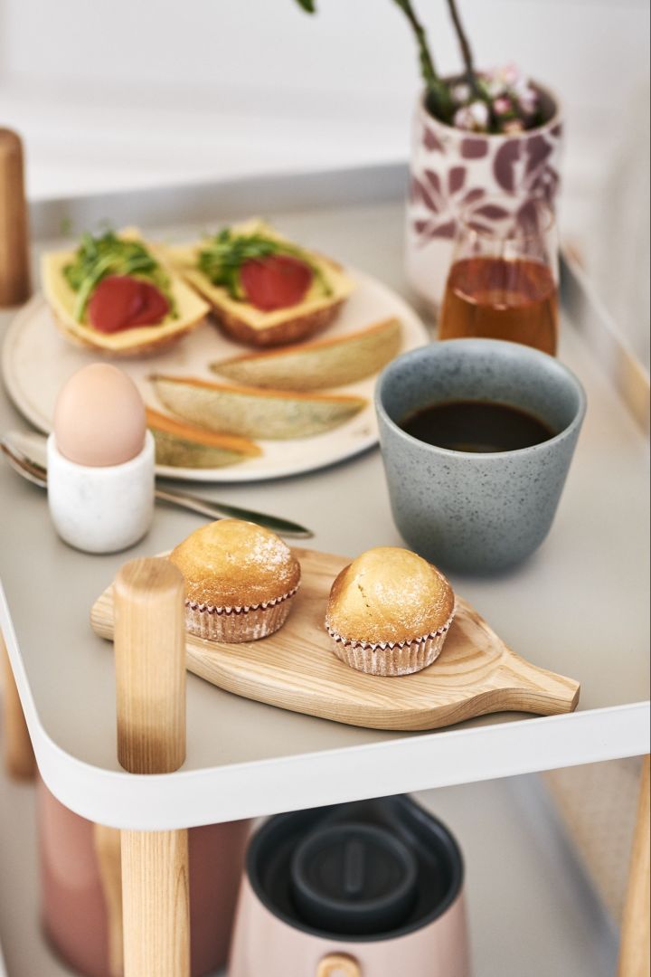 Sweet muffins served on a wooden tray together with freshly brewed coffee for a luxurious breakfast and a good start to the weekend.
