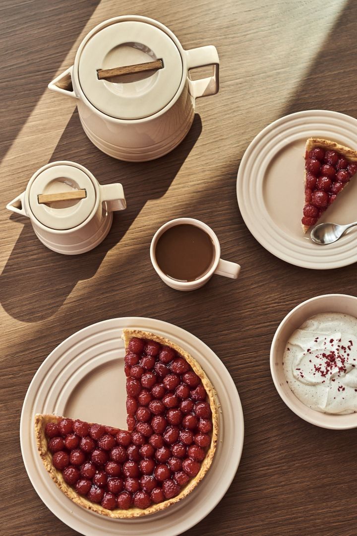 Raspberry pie sits on the Line's plate along with Line's jug, bowl and mug in beige from NJRD - just some of our 7 beige interior design favorites to invest in this autumn.