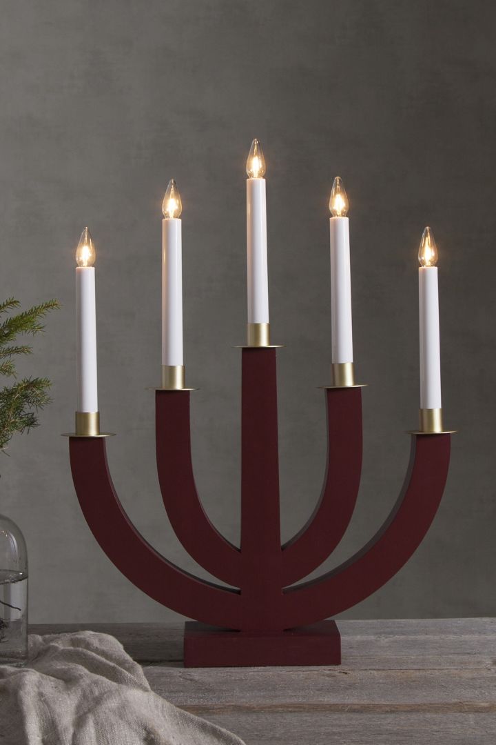 How to decorate with traditional Scandinavian Christmas decorations - The Eli candle arch from Star Trading in red adds a Scandi atmosphere to your home during the long winter nights