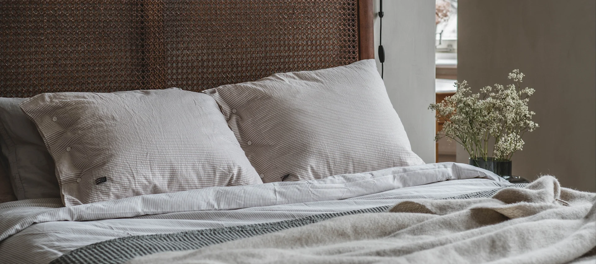 Create a cosy bedroom with neutral colours and quality bedding.