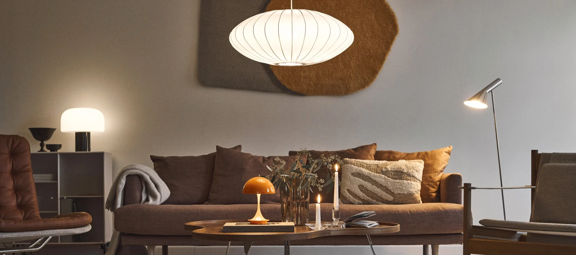 Here you see the Nelson Bubble ceiling light from HAY hanging over a coffee table in a living room. 