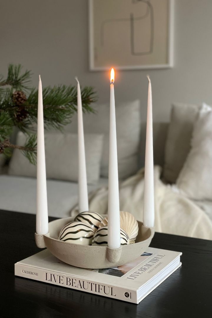 How to decorate with traditional Scandinavian Christmas decorations - The Bowl advent candle holder in beige from Scandi Living is an elegant candle holder that looks like as lovely on the sideboard as the dining table.  Seen here at the home of @myjapandihome.