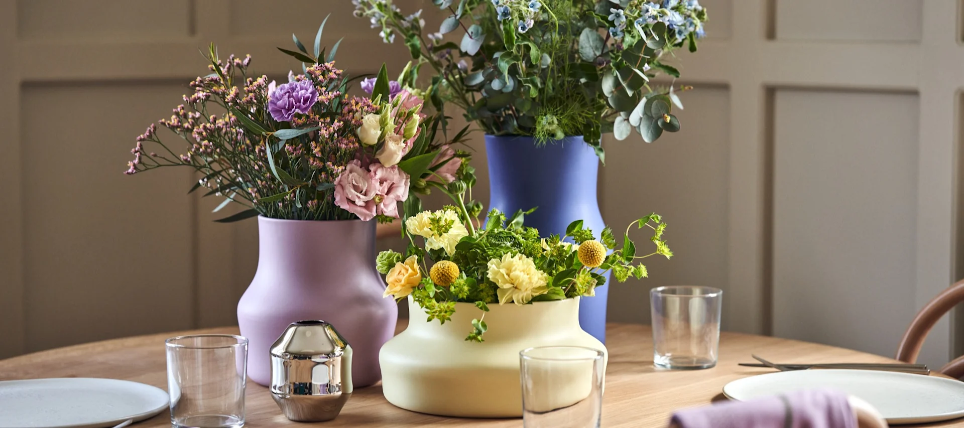 The Alvar Aalto vase from Iittala stands on a sideboard, the best vase for cut flowers.