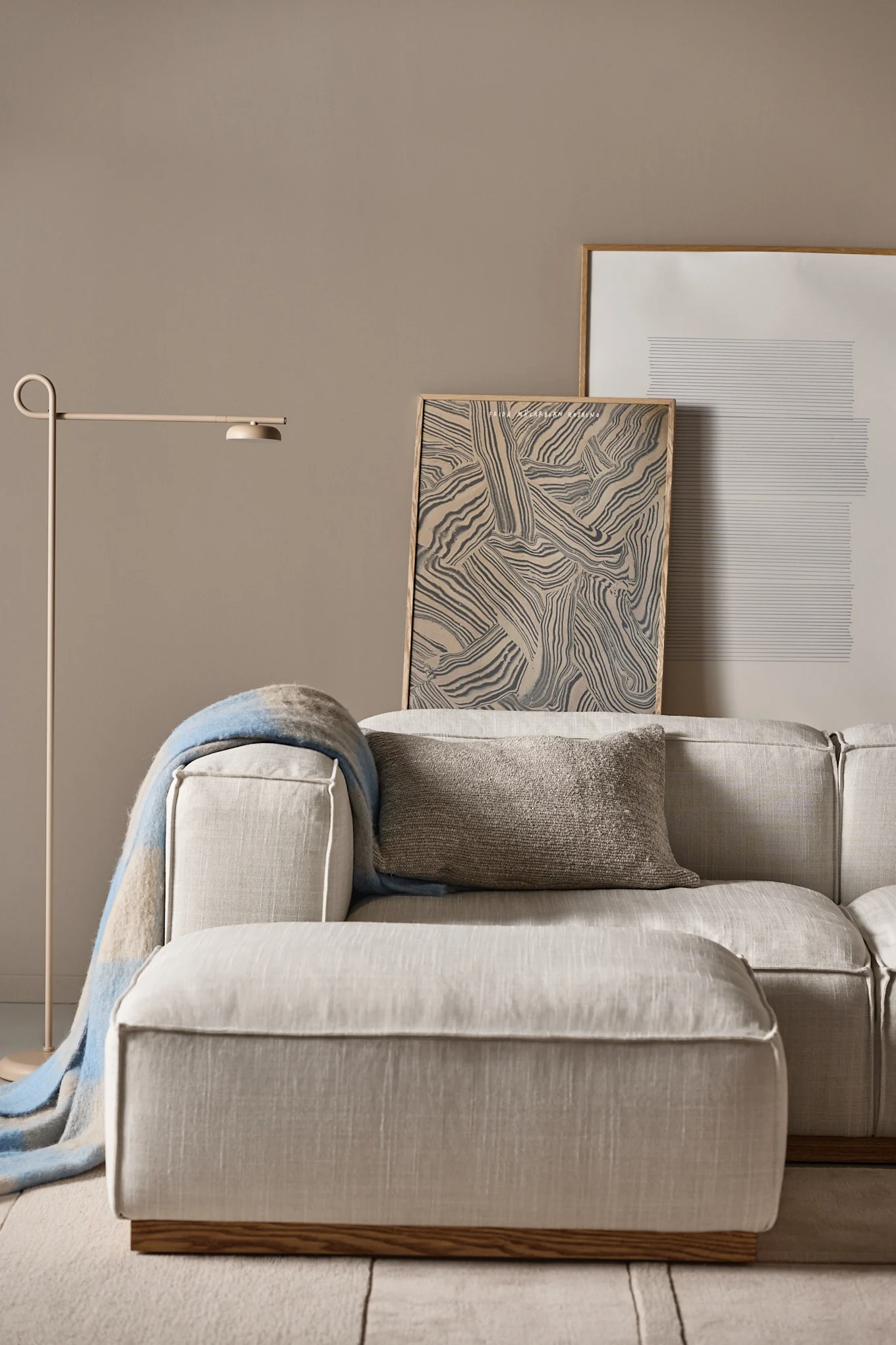 Large modular sofa from 1898 in beige upholstery, here in neutral living room, is just right according to Scandinavian interior design trends 2025 and trendy interior design.