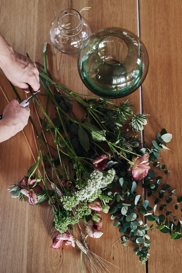 A bouquet of flowers get a fresh cut to allow them to soak up more water.
