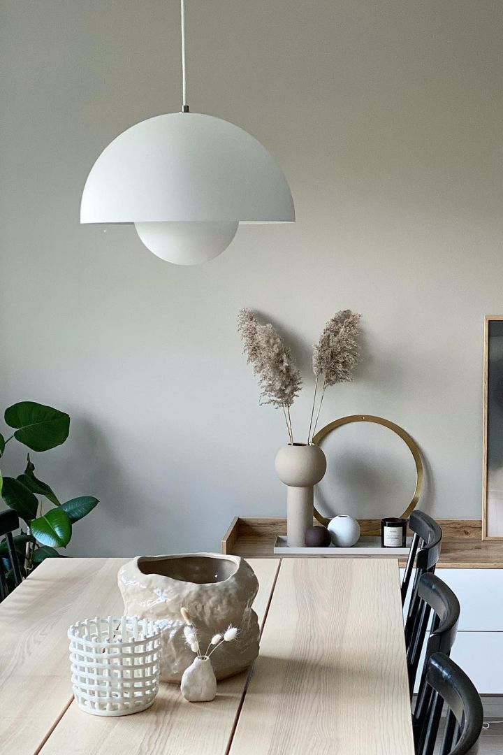 11 stylish ceiling lights to decorate your home with - here you see the Flowerpot pendant lamp VP7 from &Tradition hanging over a wooden dining table. 