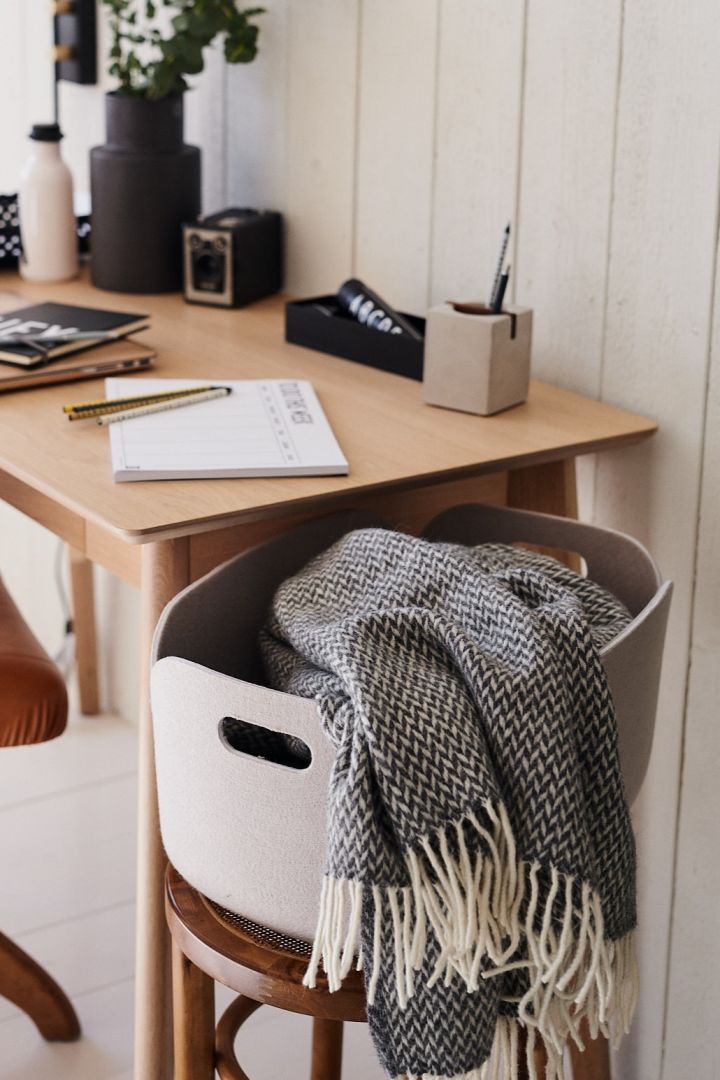 Decorate your small office with stylish storage like the Restore storage basket from Muuto, perfect for a cosy throw to keep you warm while you work. 