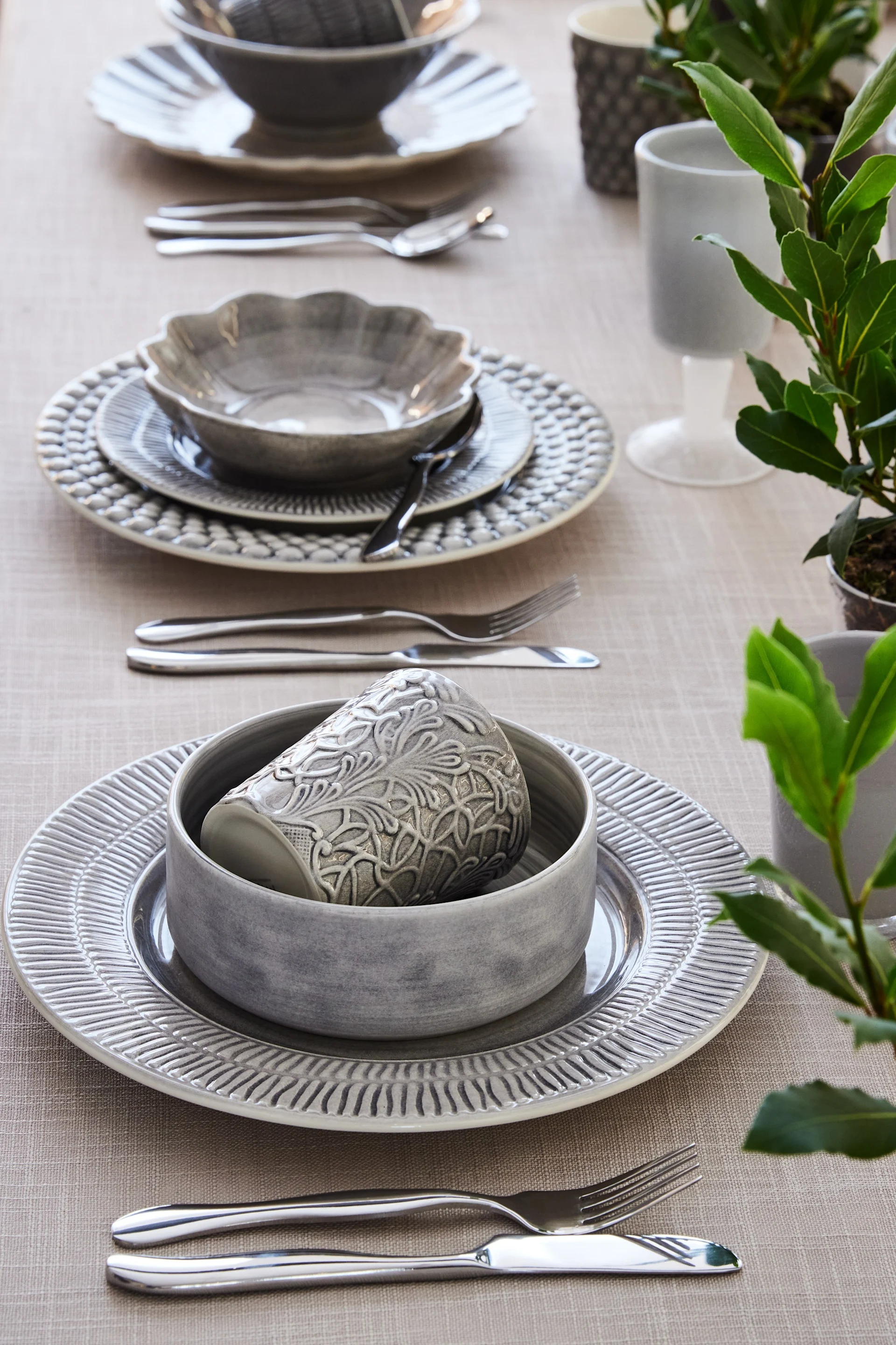 A table set with grey tableware from the Stripes, MSY and Lace collections by Mateus.