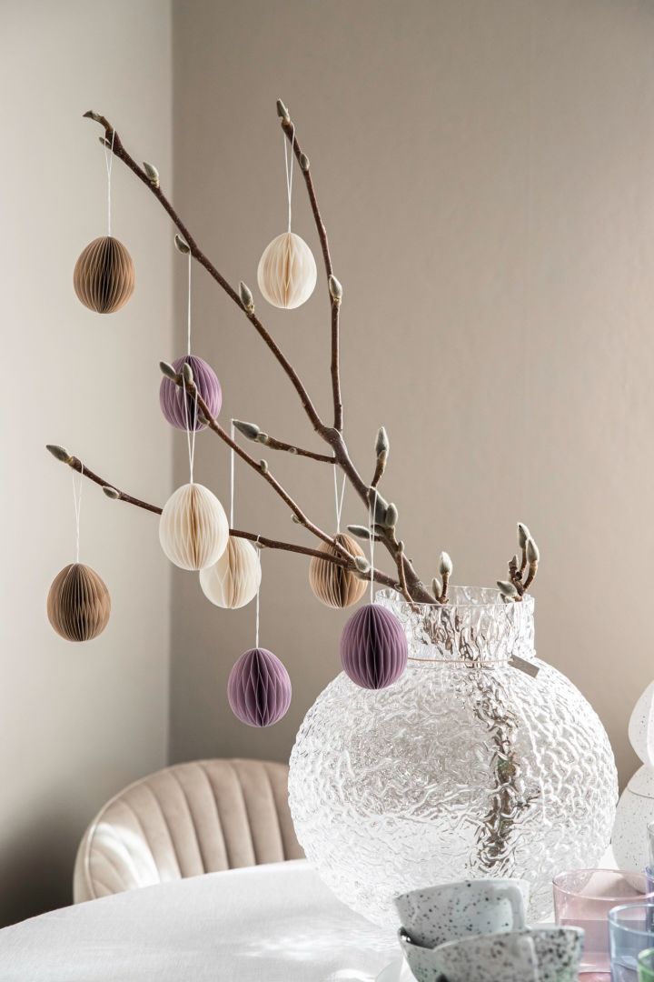 Decorate your Easter tree with simple paper decorations like you see here with a single branch decorated with paper eggs. 