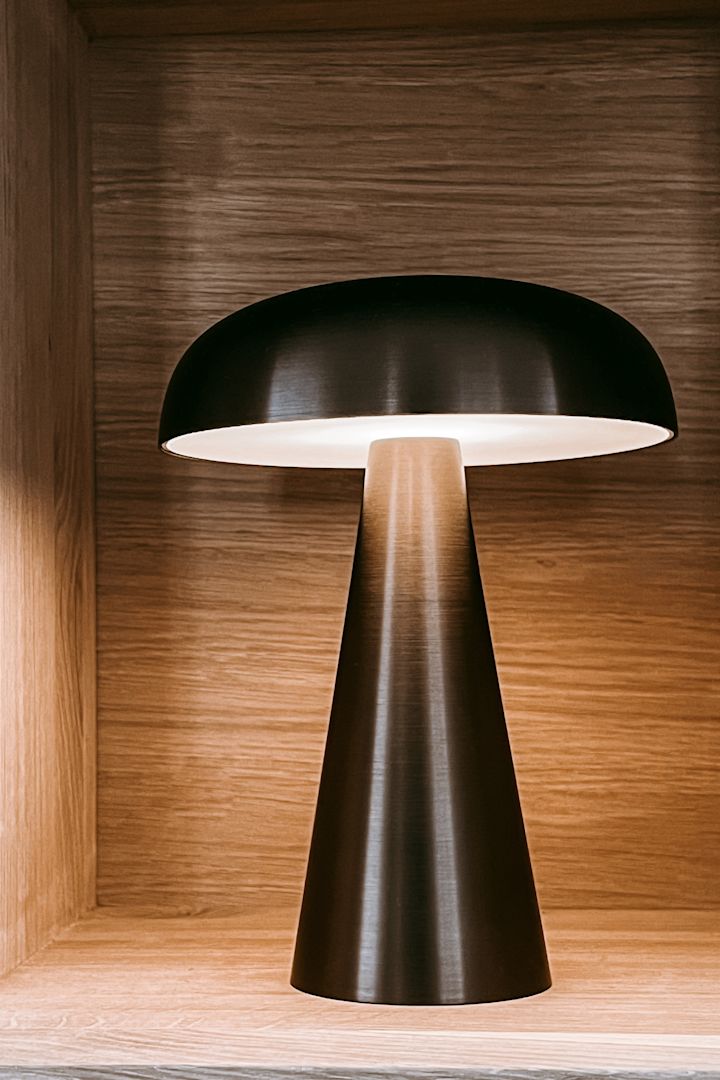 Bookshelf decor ideas - inspiration from Anela Tahirovic's home @arkihem where a portable lamp such as Como from &Tradition is perfect to style your bookshelf with.