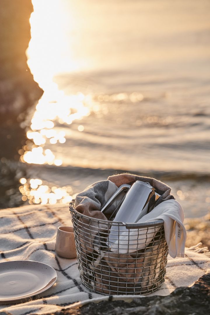 The Korbo metal basket is a real summer essential, seen here packed for a picnic on the beach.