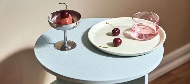 Our interiors for 2022 will include soft pastels inspired by the 80's, here the Tint drinking glass and the Italian Ice Cup dessert bowl, both from HAY sit on top of the Teema plate from Iittala accompanied by ice cream and cherries.
