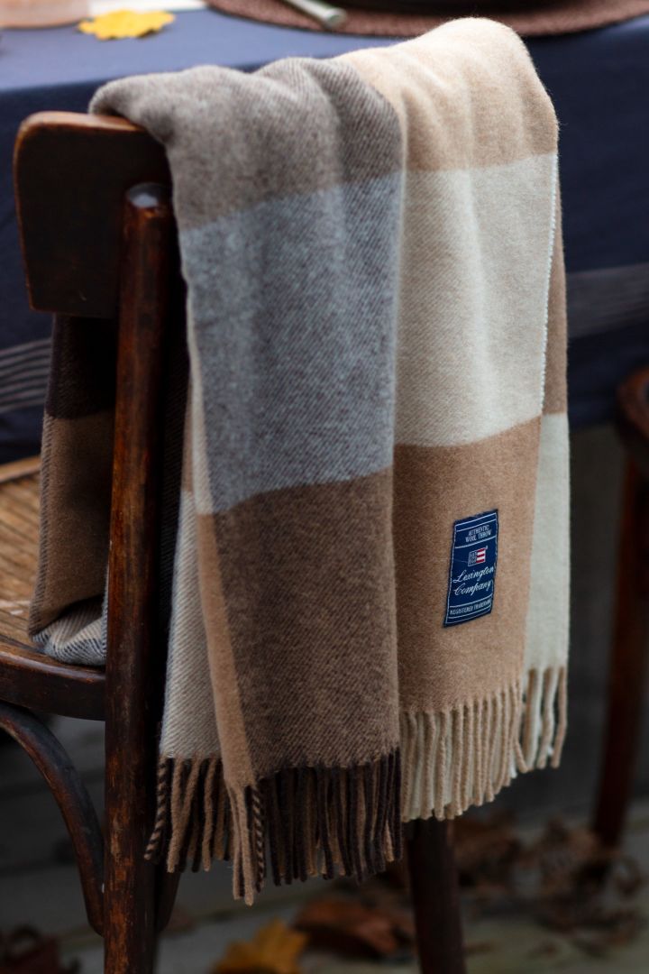 One of the autumn interior design trends 2021 is checks, here you see Lexington Checked wool blanket in autumn beige and brown tones.
