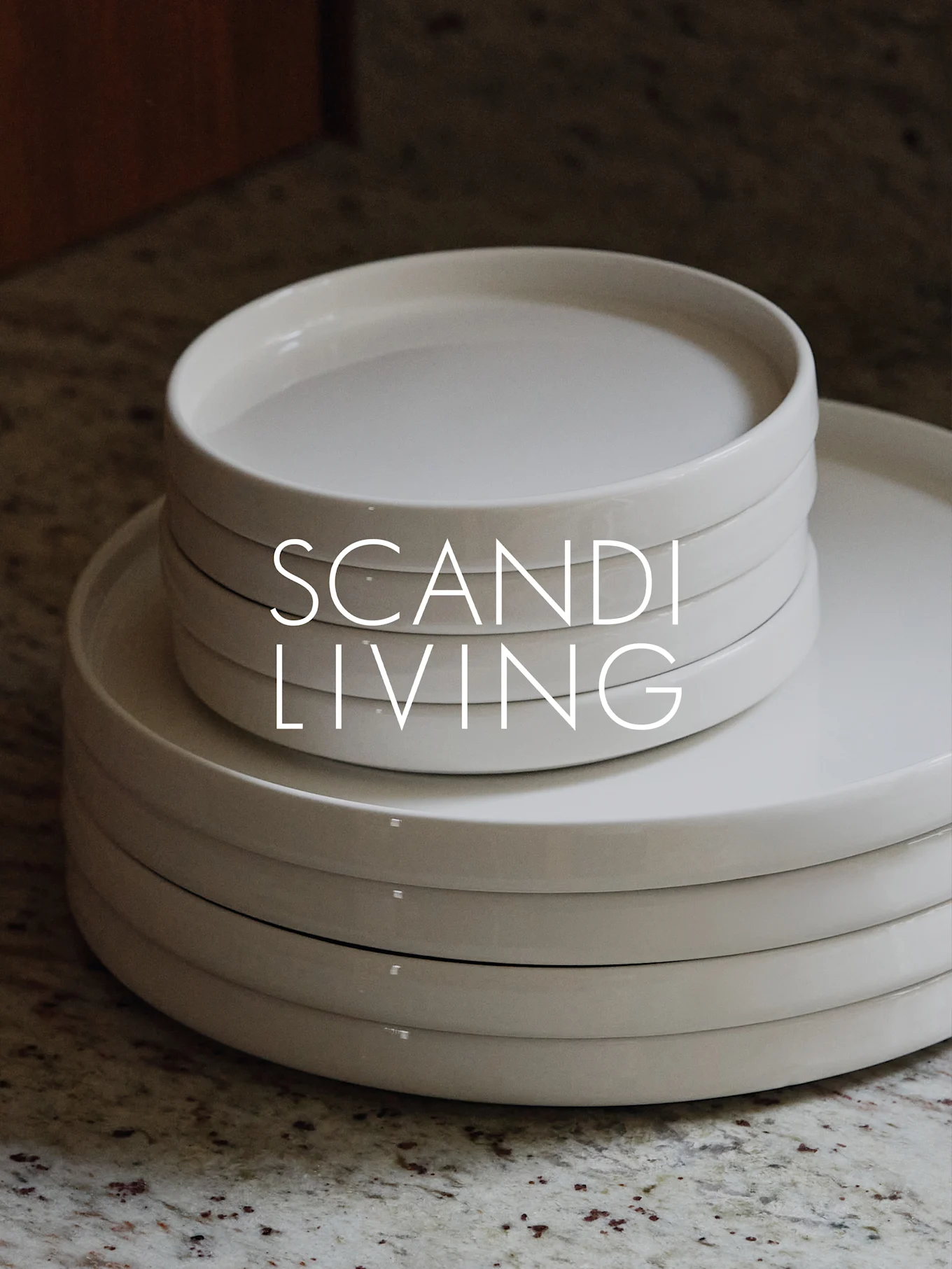 Two stacks of light cream ceramic plates on a speckled countertop with 'SCANDI LIVING' overlaid.