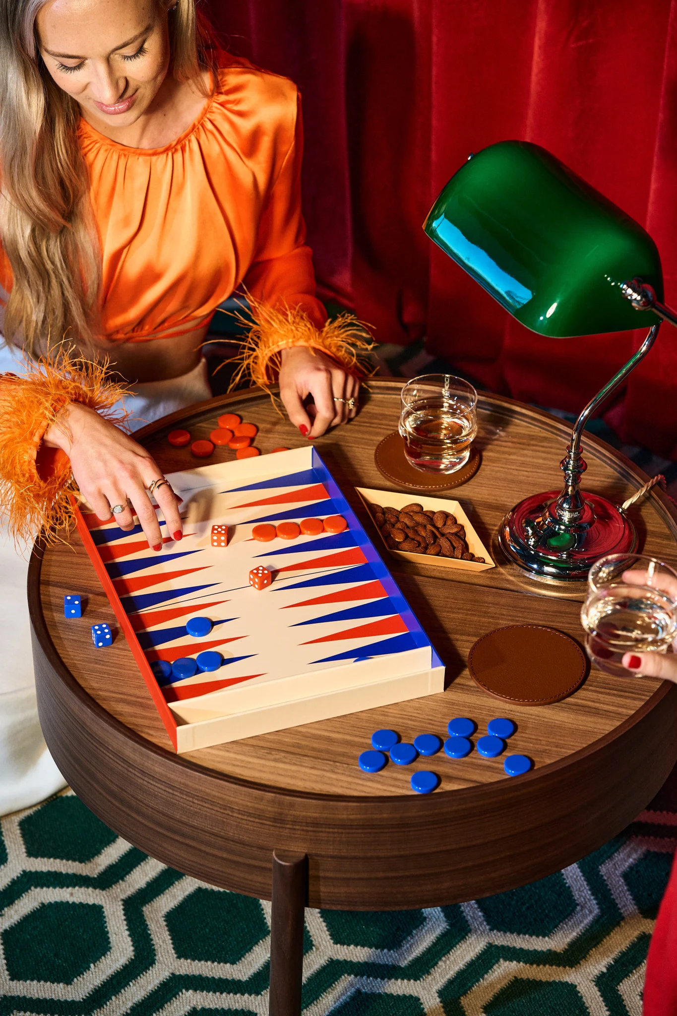 How to throw a party with traditional games like backgammon here seen in a retro setting with a traditional green lamp from Fritz Hansen. 
