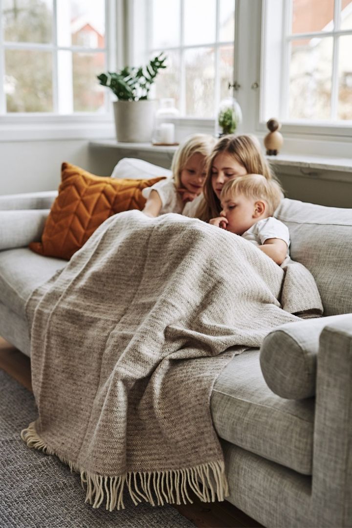 Create a cosy hygge living room with tactile textures and cosy wool throws. 