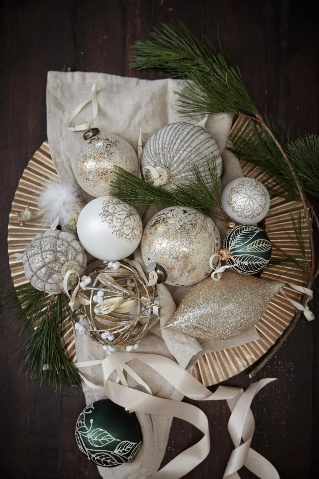 Various Christmas baubles by Lene Bjerre are displayed as Christmas decorations on a table.