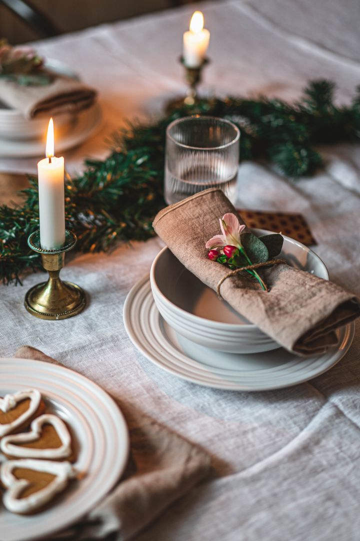 A white Christmas table setting with simple plates from NJRD a great Christmas gift idea for lovers of Swedish design. 