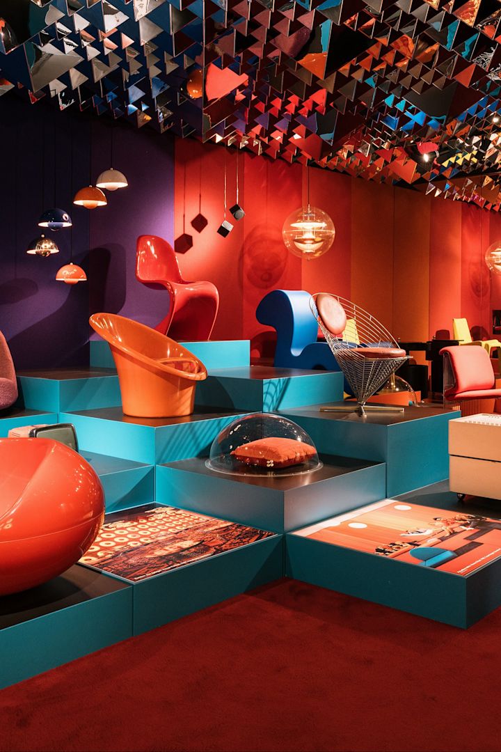 The Design Museum Copenhagen is a great place to check out classic Danish design. Here you see a clashing  red and blue room with lamps and chairs.
