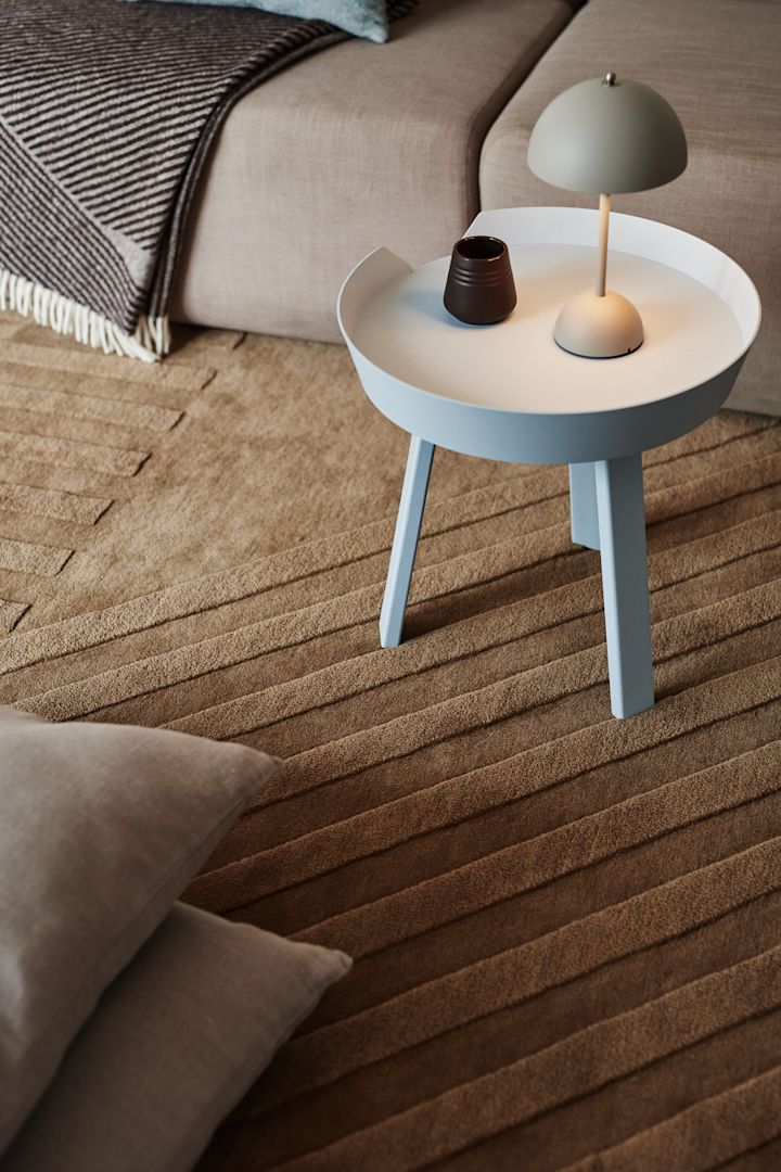 Levels wool rug Stripes beige from NJRD and Flowerpot VP9 table lamp from &Tradition give your home a cosy feeling.