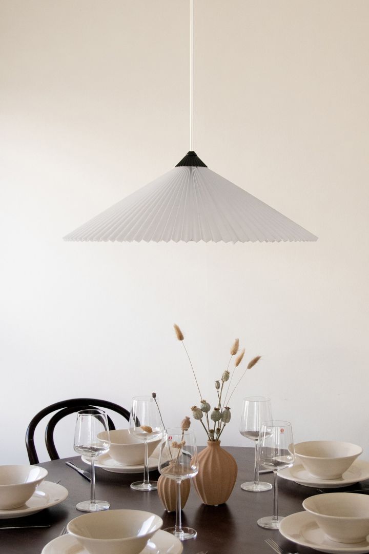 Refresh your home with modern pendant lamps - here you see Matisse pendant lamp from Globen Lighting in pleated material that creates a cozy feeling at dinners.