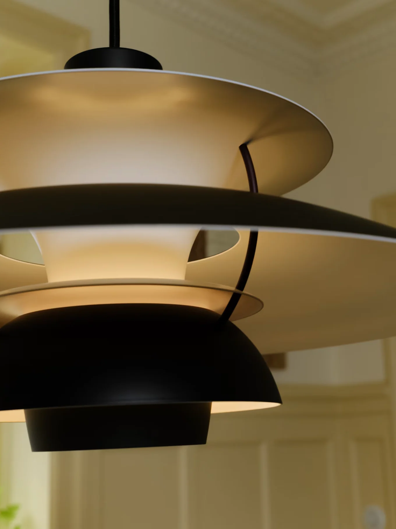 A modern, multi-layered pendant lamp with black exterior shades and light-colored interior shades, illuminated from within.