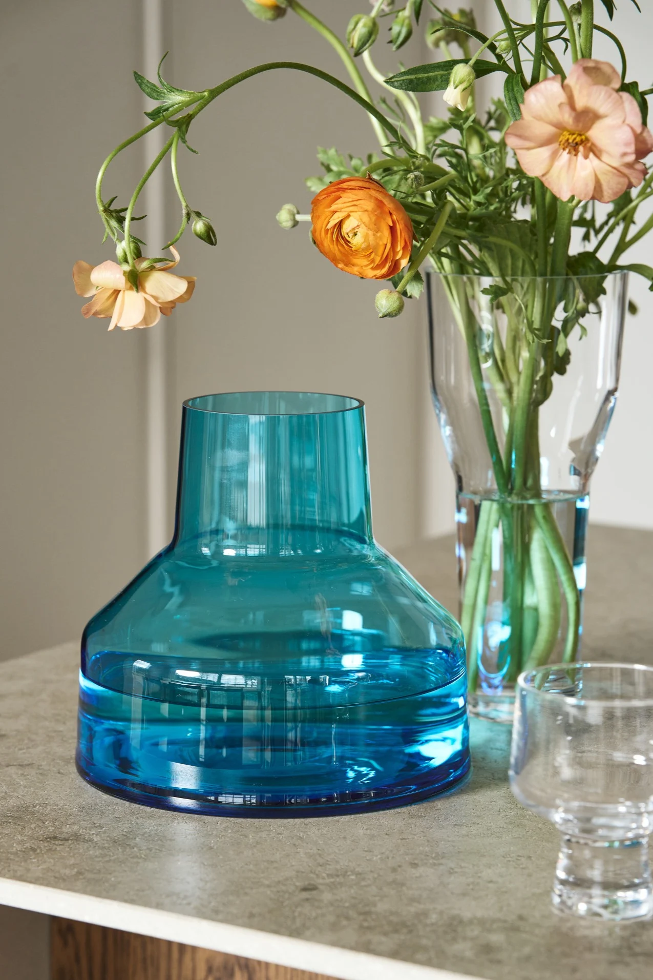 Here you see a blue funnel shaped vase part of the Solare collection from Iittala
