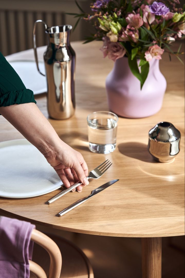 A hand places a fork from the original Dorotea cutlery collection for Swedish brand Gense, on the table.  