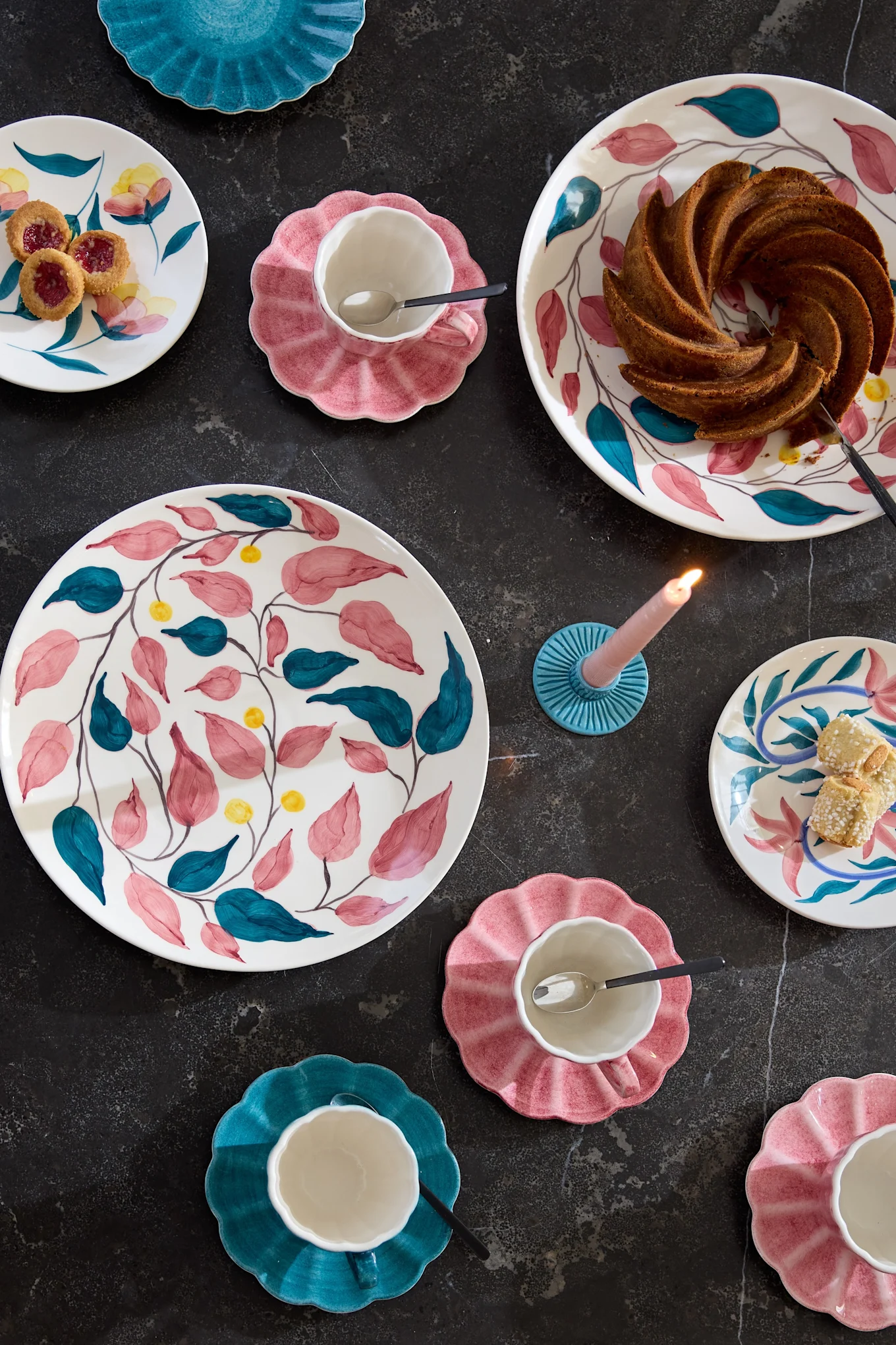 A table set with colourful tableware from the Flowers collection by Mateus.