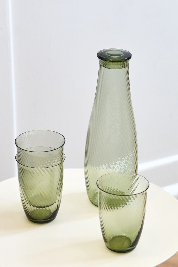 The retro style is back as one of the interior design trends for spring 2023, where we like to decorate with fluted green glass like these glasses and this decanter from &Tradition.