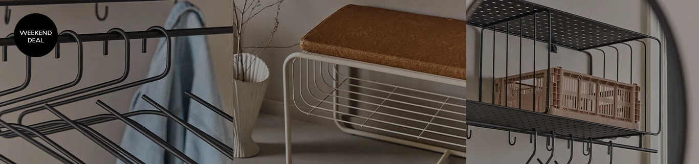 Black hangers and a 'Weekend Deal' tag, a white bench with a brown cushion, and a black perforated shelf with a brown crate.