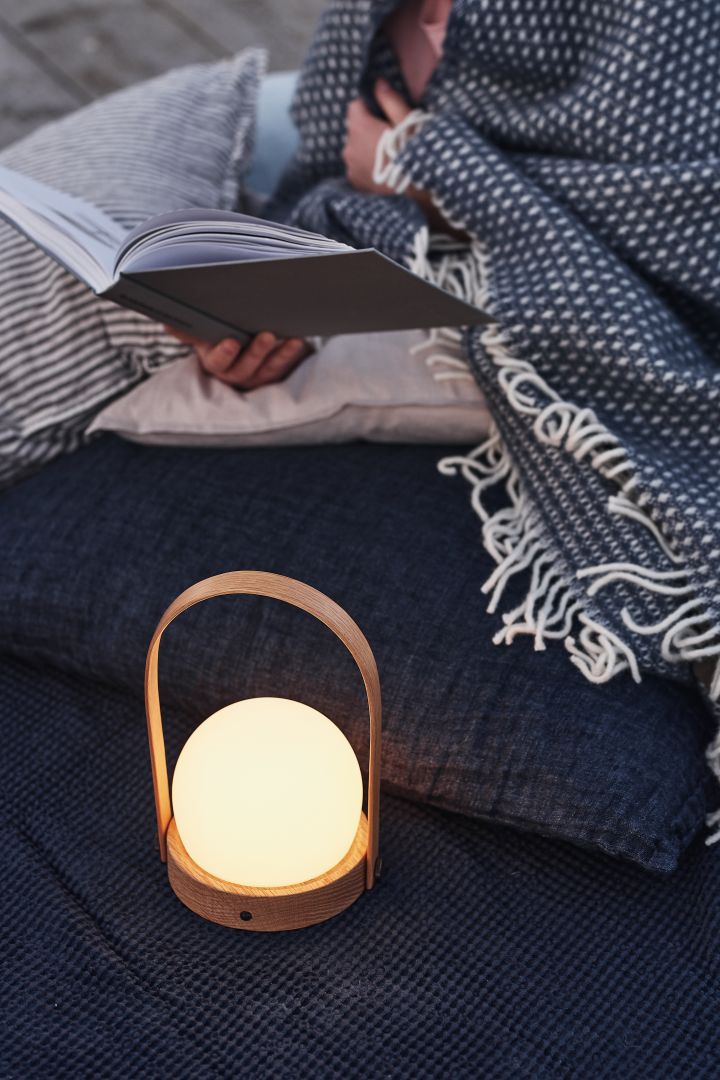 Cosy patio decor ideas - Create a cosy patio by decorating your patio with warm lighting such as the Carrie portable table lamp that you can take with you everywhere.