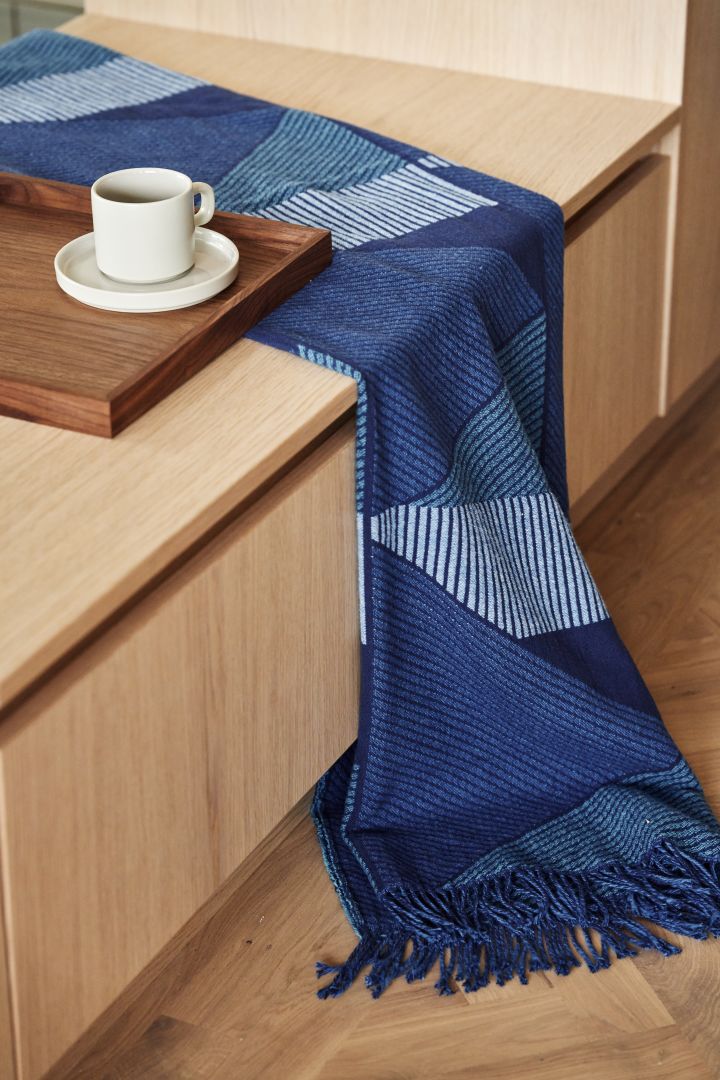 The interior trends for spring 2023 offer artistic interiors where this blue throw from NJRD is a nice contrast to the beige and minimalist.