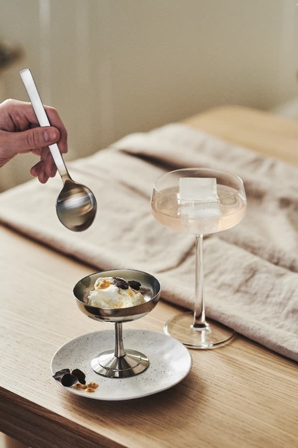 An Italian style ice cream cup stands on a plate with a  cocktail in the Essence coupe glass from Iittala. 