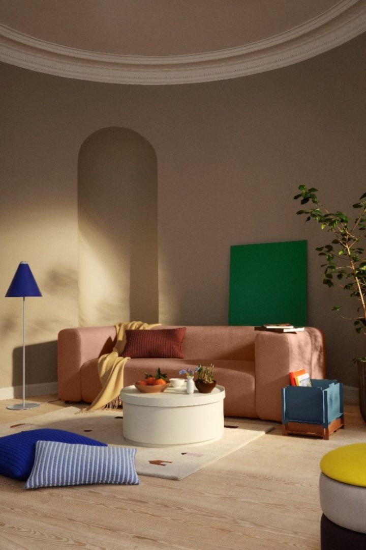 A colourful living room with furniture in the on trend colors cobalt blue, yellow, peach and green.