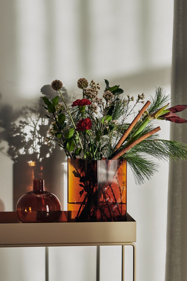 Decorating with nature's greenery is one of the spring interior design trends 2022 that you can see in these vases from Urban Nature Culture in orange tones.