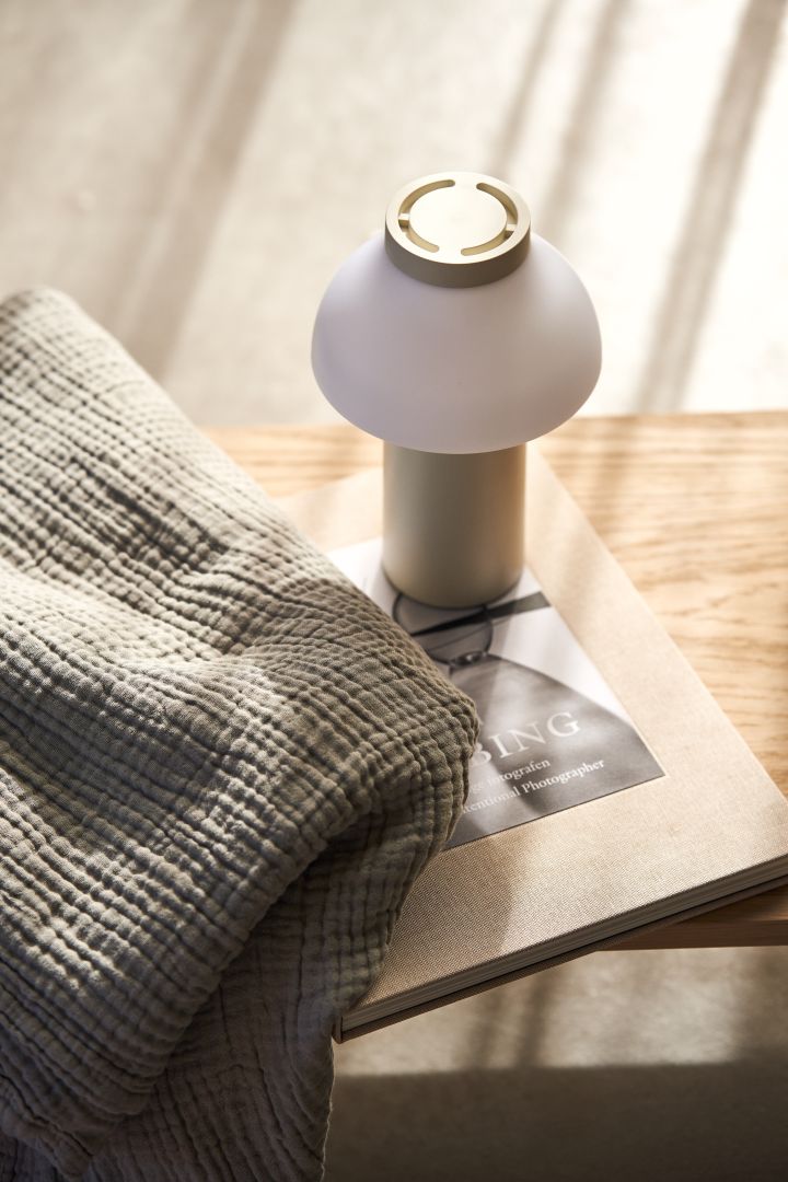 Decorate with the cordless lamp PC in cream from HAY, portable lighting is one of the interior design trends for 2022. 