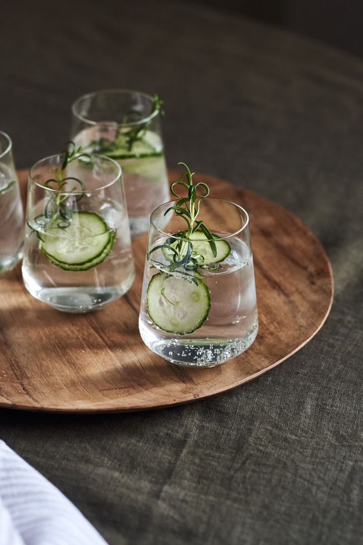 4 festive cocktail recipes for new year - Iittala Essence water glass on Muubs Teak plate.