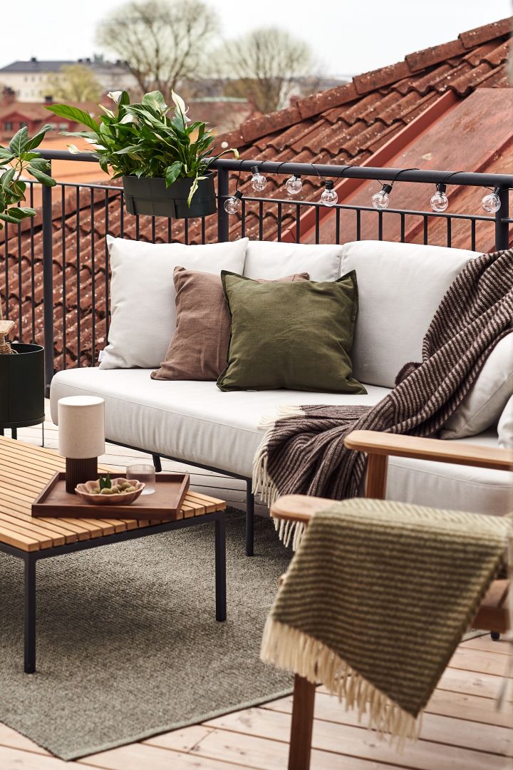 Decorate your balcony with soft textiles such as this wool throw from NJRD to create a homely feeling. 
