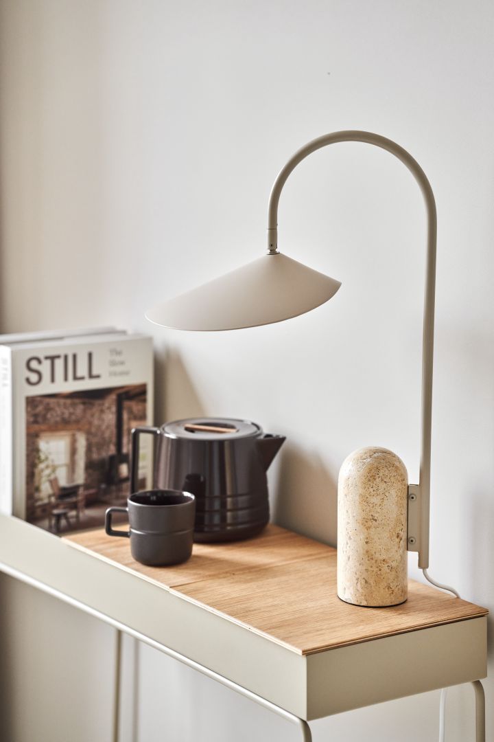 Refresh your home with modern table lamps - here you see Ferm Living Arum table lamp in tones of beige next to the Lines mug and teapot from NJRD on Ferm Living Plant Box.