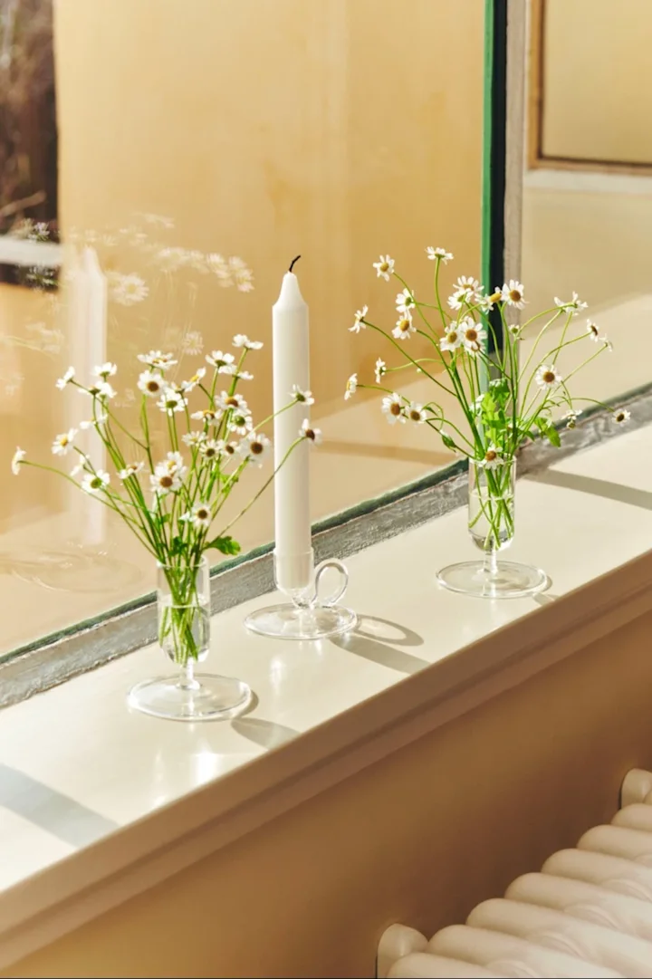 Group similar items to make your home appear more organised and less cluttered. Here you see the tiny vases from HAY accompanied by a candle holder from the same series. 